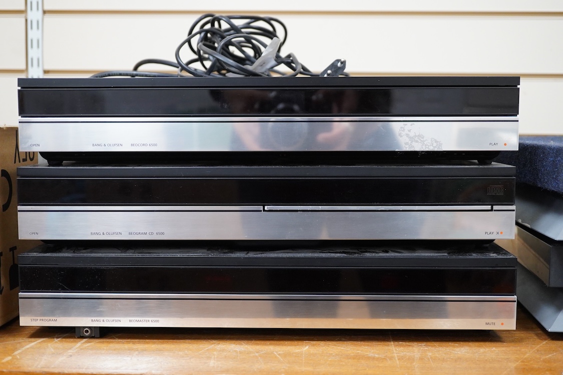 A Bang and Olufsen 6500 hi-fi system, comprising of a Beocord 6500, a Beogram CD 6500, a Beomaster 6500, and a master control panel, together with a pair of floor standing pedestal speakers, 164cm high, and pair of type